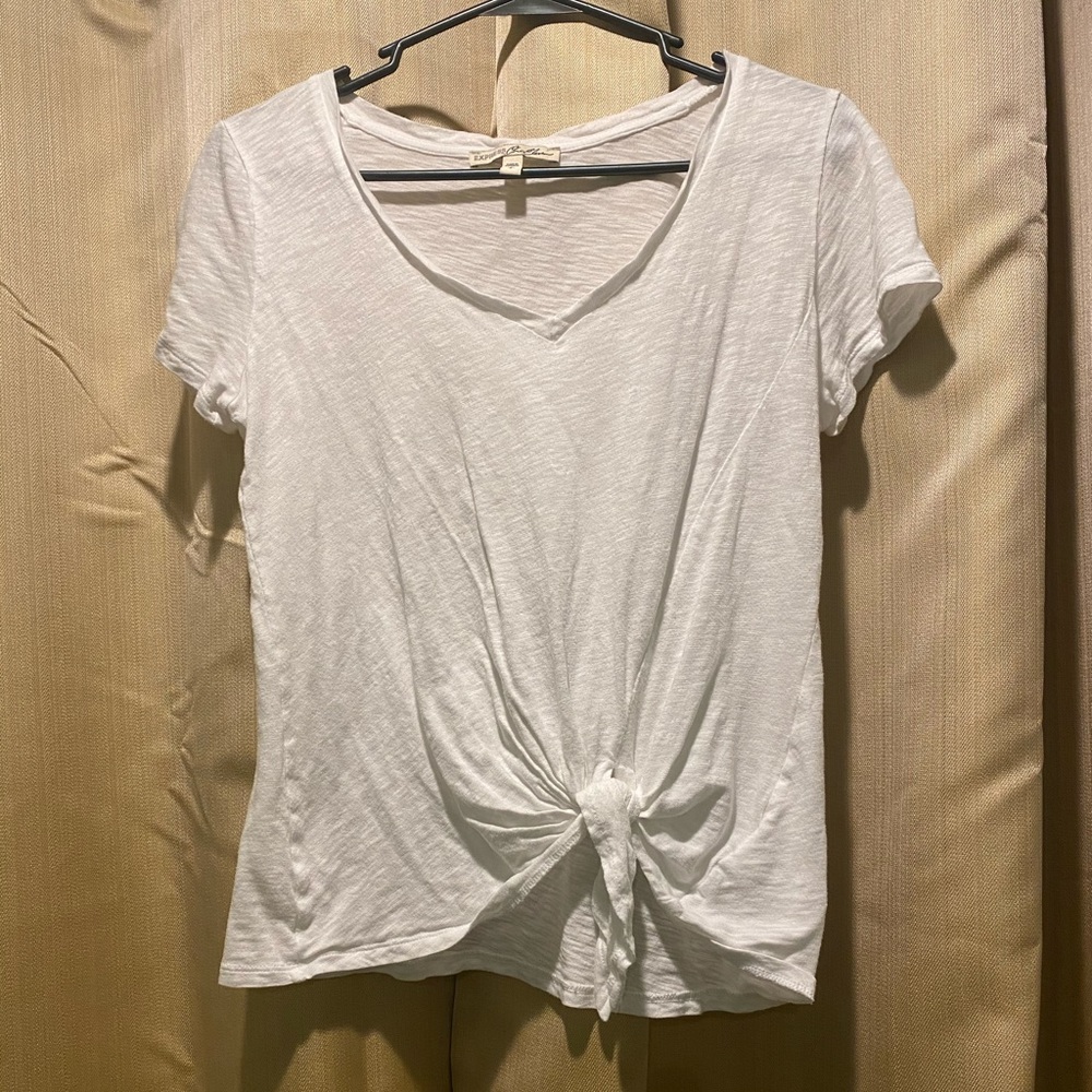 Plain white v-neck, with tie a tie in front.